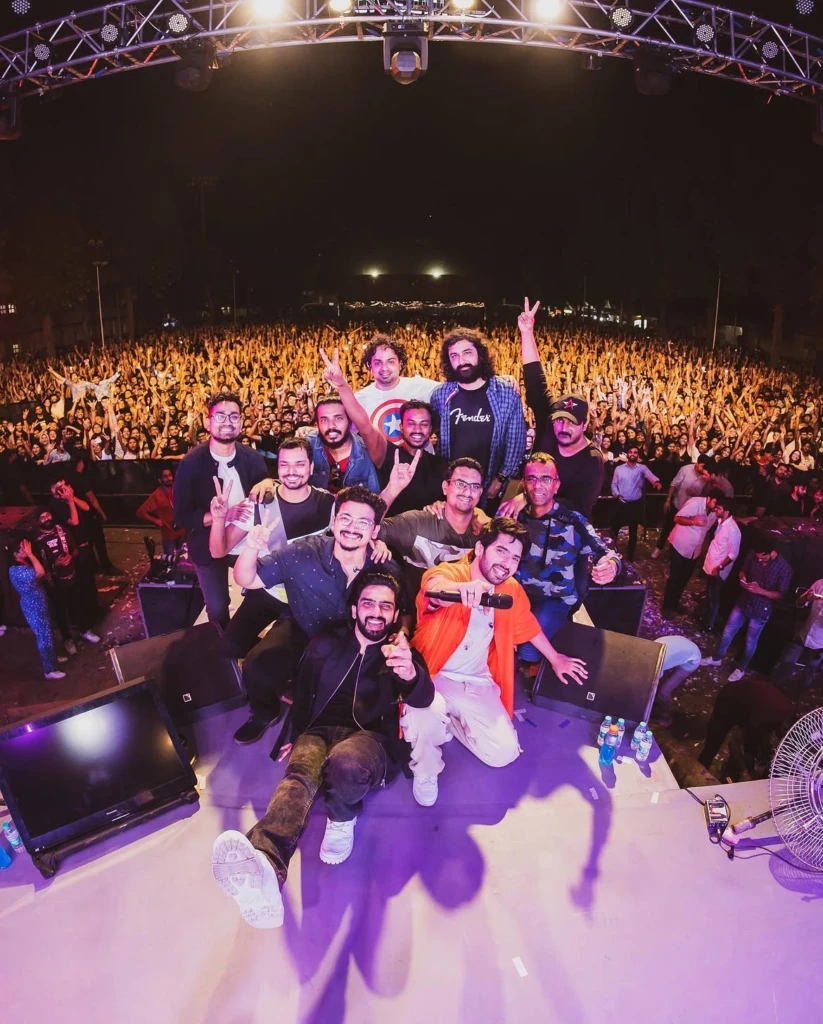 Amaal Mallik and Armaan Malik posing with their crew during a performance